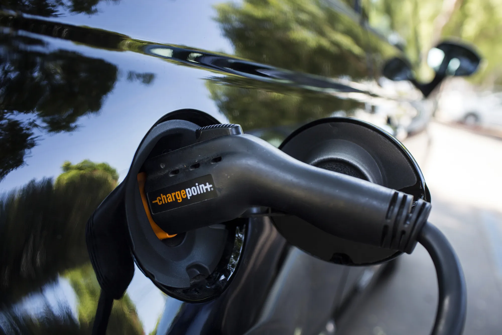 A ChargePoint Inc. charging plug sits connected to an electric vehicle at a station in Los Angeles, California.