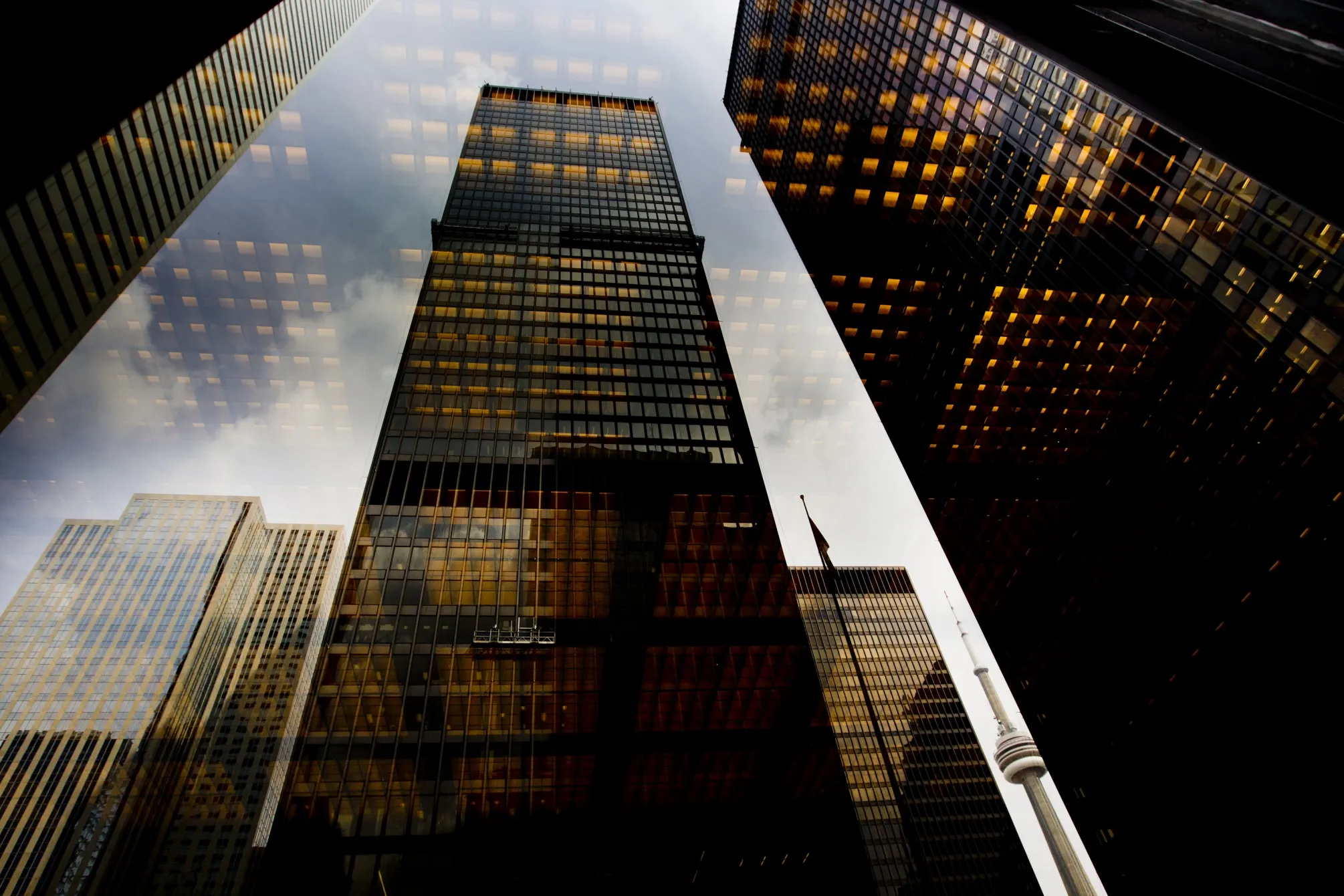 Bank towers are reflected in a window in Toronto’s financial district