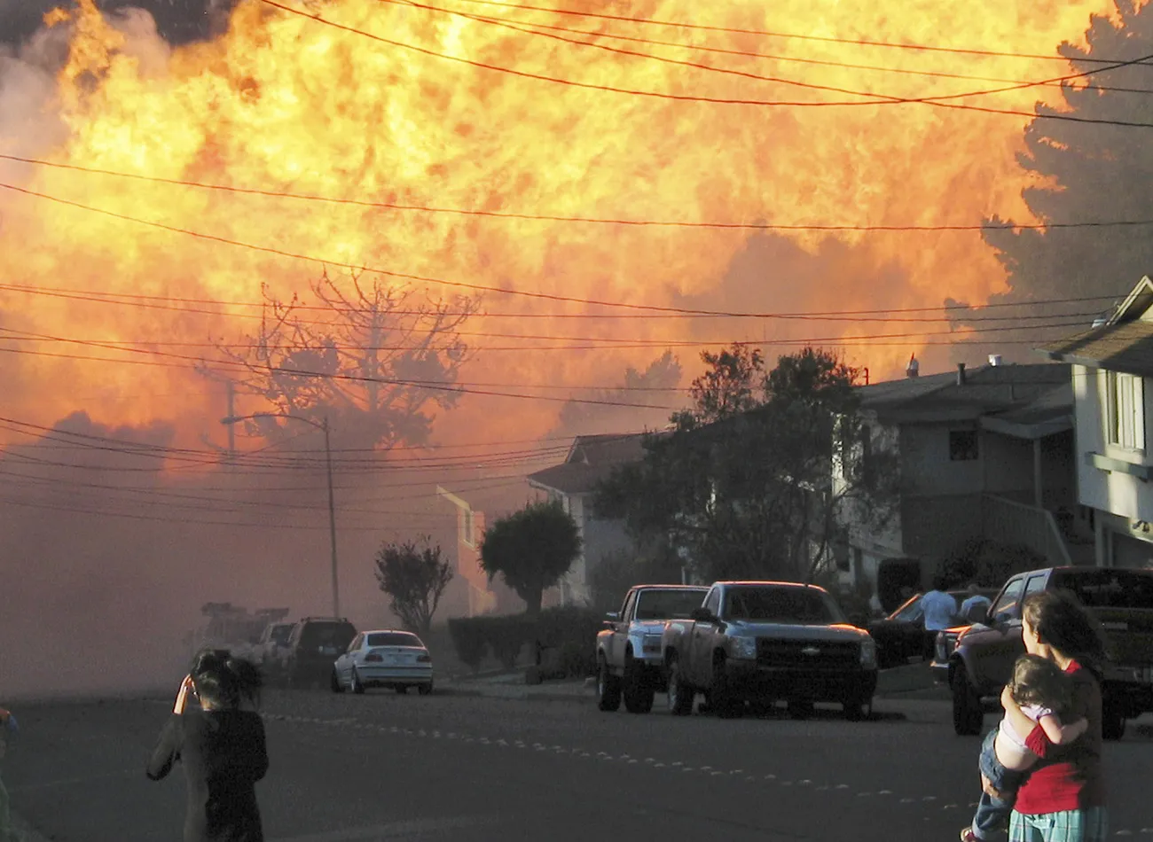 In this Sept. 9, 2010 file photo, a massive fire roars through a mostly residential neighborhood in San Bruno, California.
