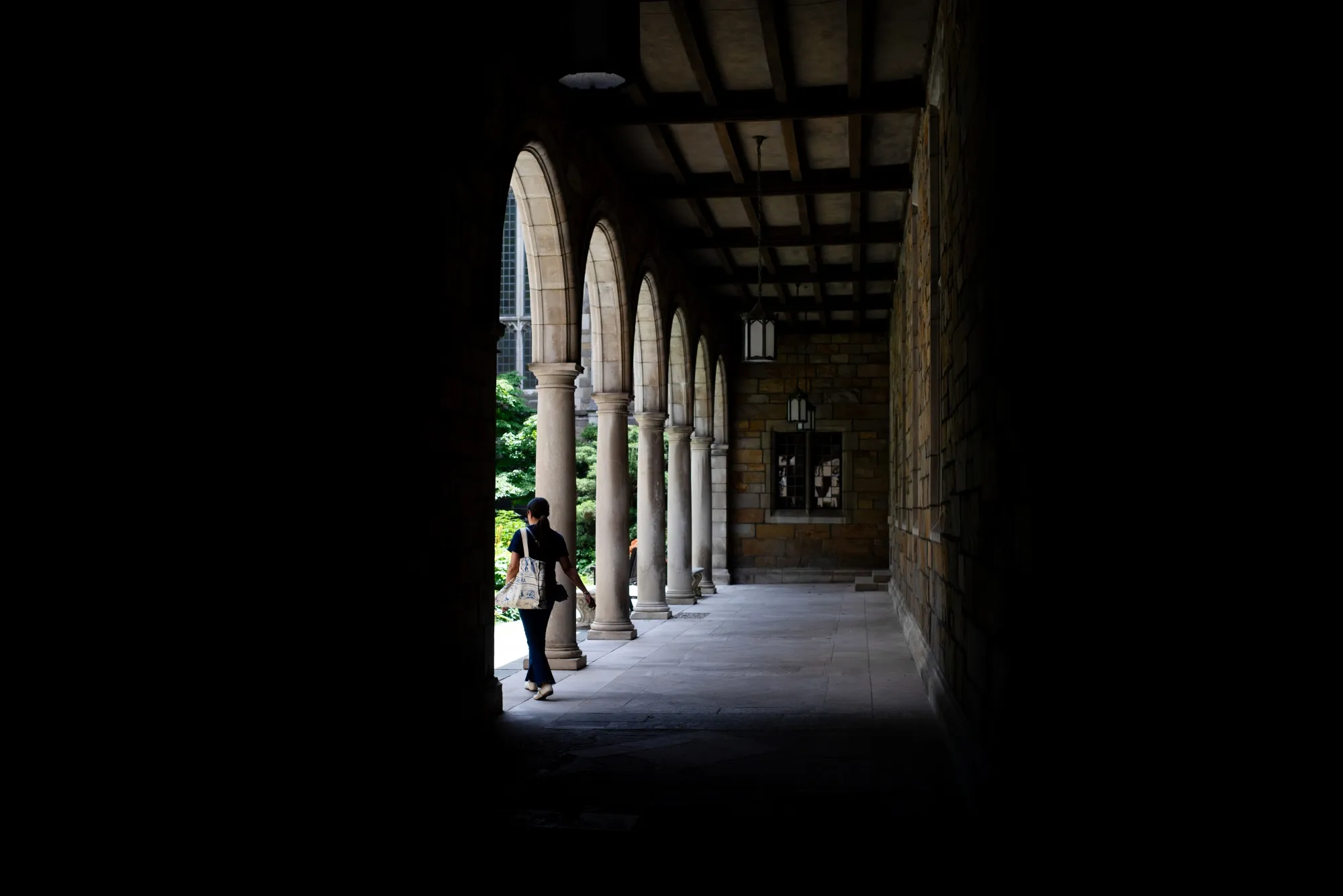 A student walks through the Law Quad at the University of Michigan in Ann Arbor, Michigan, US, on Monday, July 28, 2025.