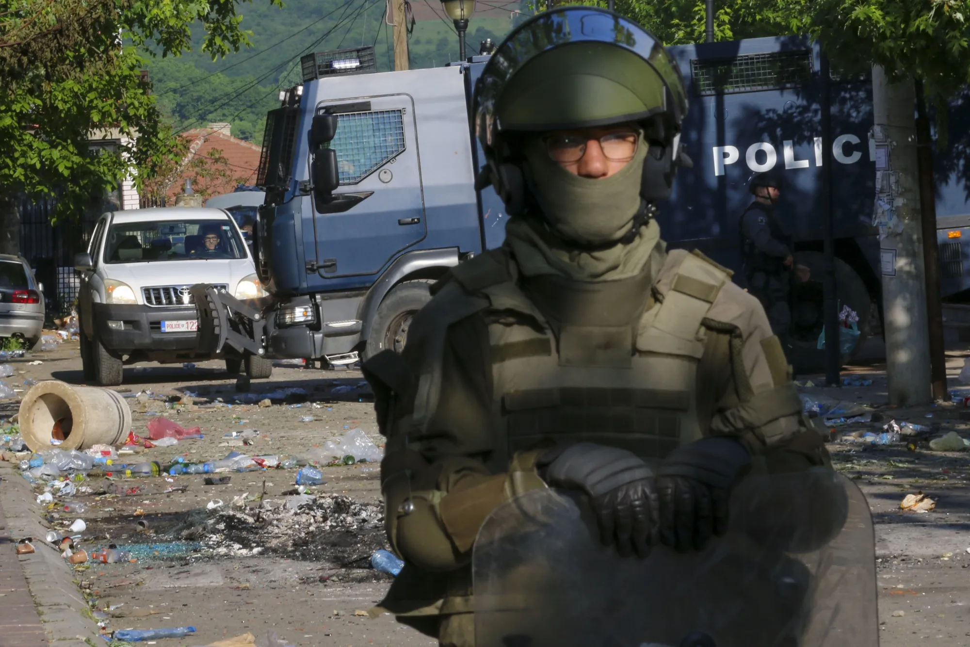 A KFOR peacekeeper and Kosovan riot police in Zvecan, Kosovo, on May 30.