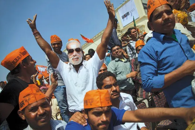 A supporter of Narendra Modi dons a mask of the Hindu nationalist candidate