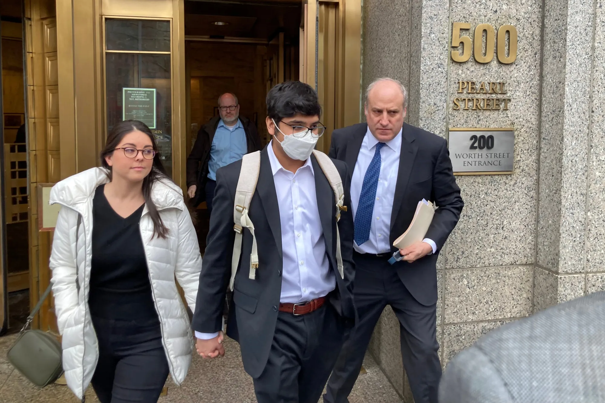 Nishad Singh, center, leaves federal court in New York.