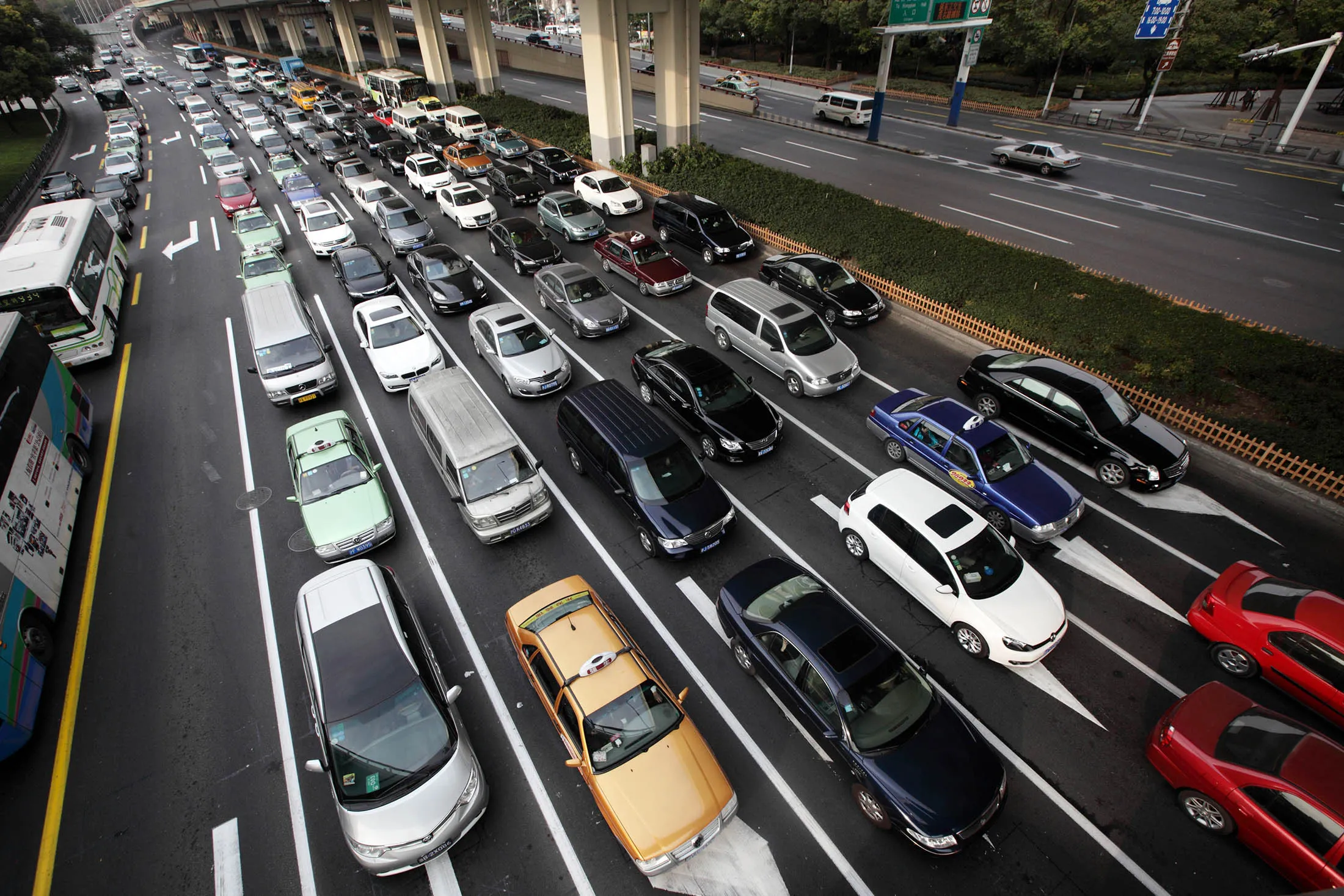 Vehicles move along a road in Shanghai, China, on Tuesday, Jan. 29, 2013. China's economic growth accelerated for the first time in two years as government efforts to revive demand drove a rebound in industrial output, retail sales and the housing market.
