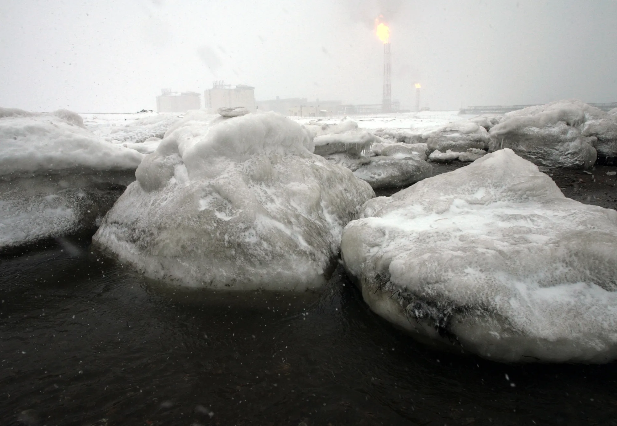 Gas flares off under heavy snowfall at an LNG&nbsp;plant on Sakhalin island.