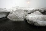 Gas flares off under heavy snowfall at an LNG plant on Sakhalin island.