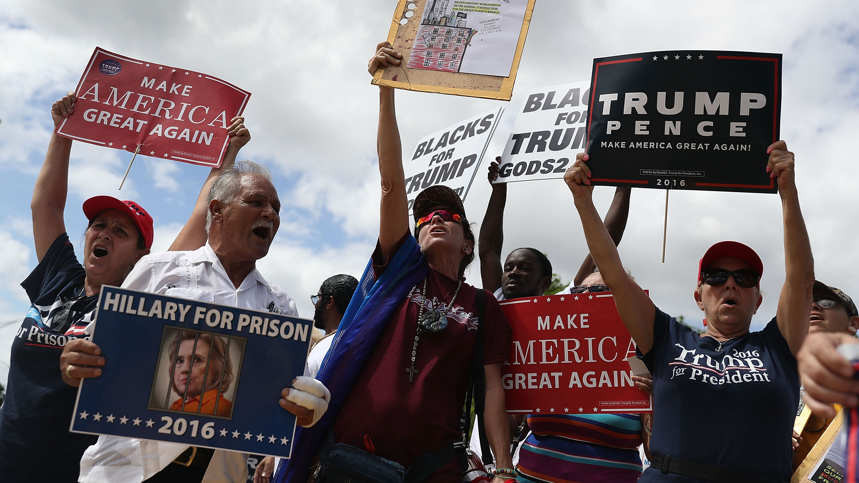 Supporters of Republican presidential nominee Donald Trump show their support for him before the start of the campaign event for Democratic presidential nominee Hillary Clinton at the Miami Dade College - Kendall Campus, Theodore Gibson Center on October 11, 2016 in Miami, Florida.
