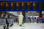 A traveler looks at departure boards at Glasgow Central station.