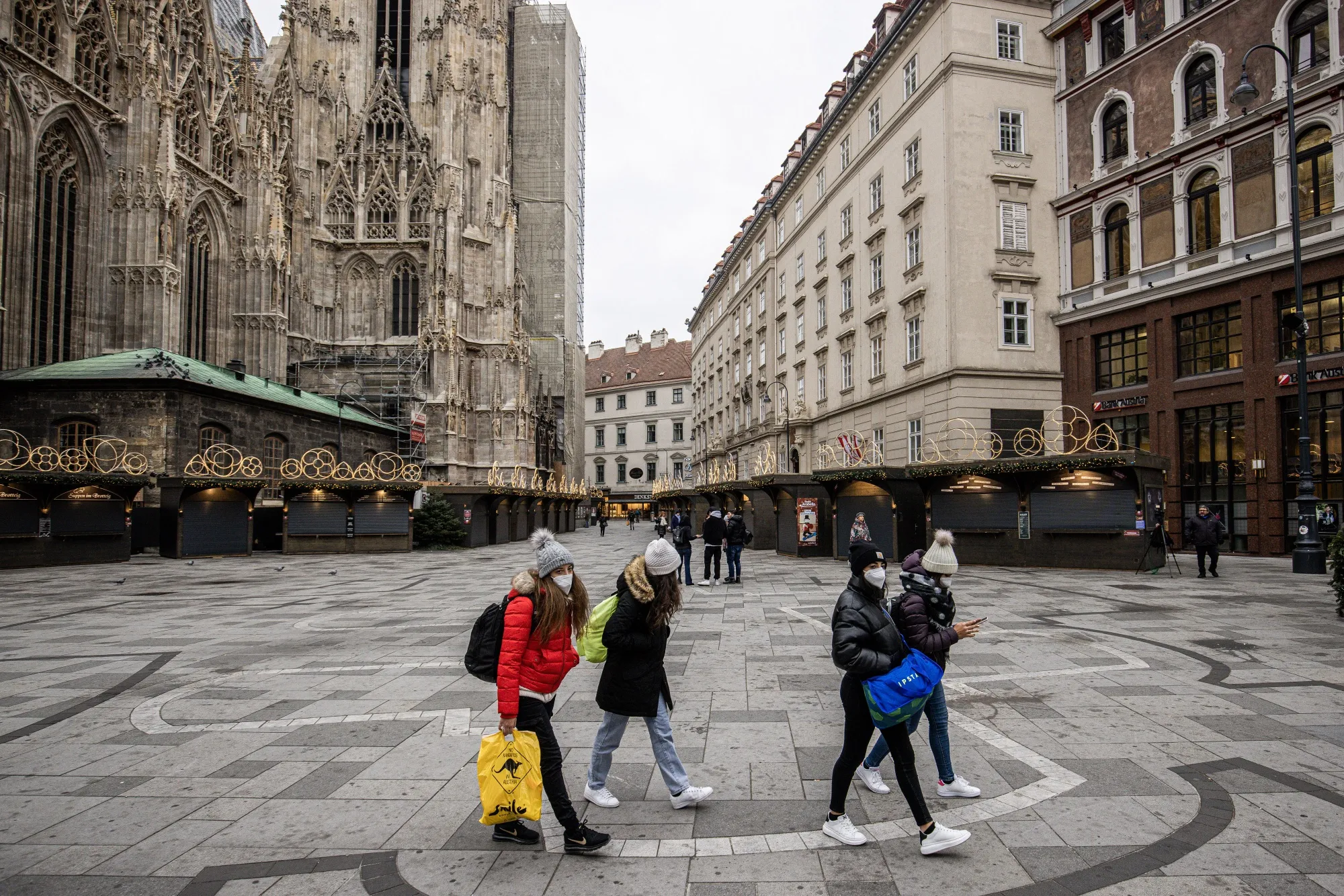 Shoppers pass a closed Christmas market&nbsp;in central Vienna, on Nov. 22.