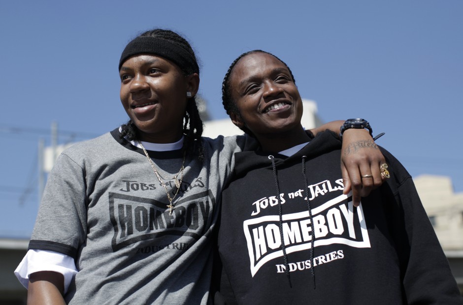 Shameeka Welch, 17, and Fallon Tooks, 27, pose outside Homegirl Cafe in Los Angeles, which is staffed by at-risk and formerly gang-involved young women training to learn restaurant and catering work. 