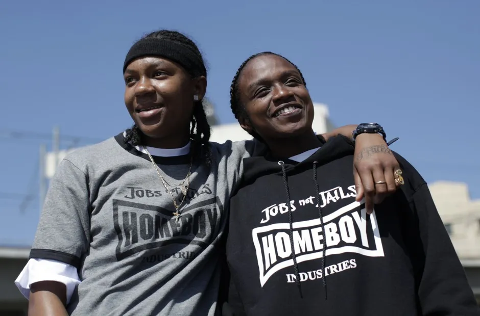 Shameeka Welch, 17, and Fallon Tooks, 27, pose outside Homegirl Cafe in Los Angeles, which is staffed by at-risk and formerly gang-involved young women training to learn restaurant and catering work. 