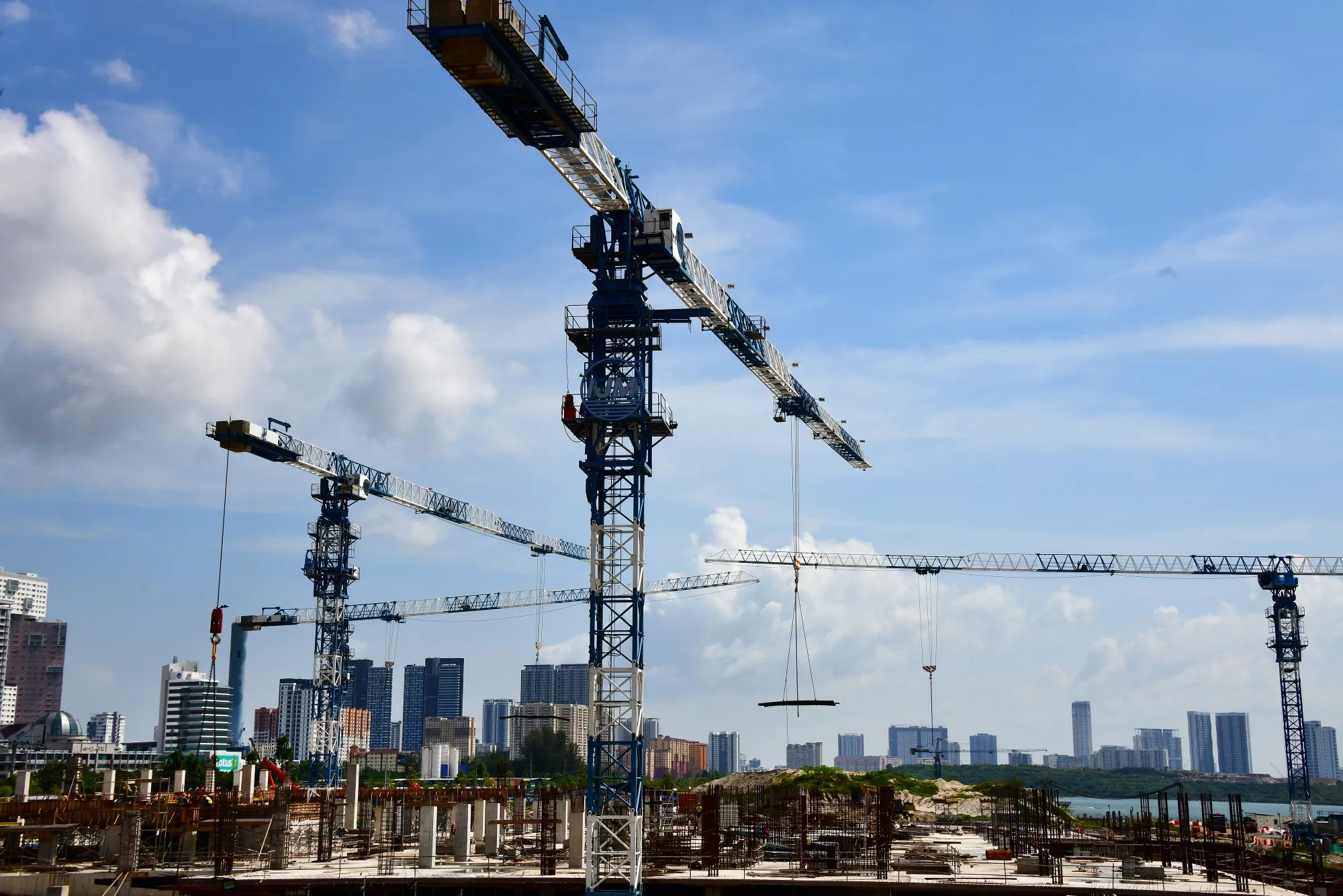 Cranes operate at an IJM Corp construction site in Penang, Malaysia.