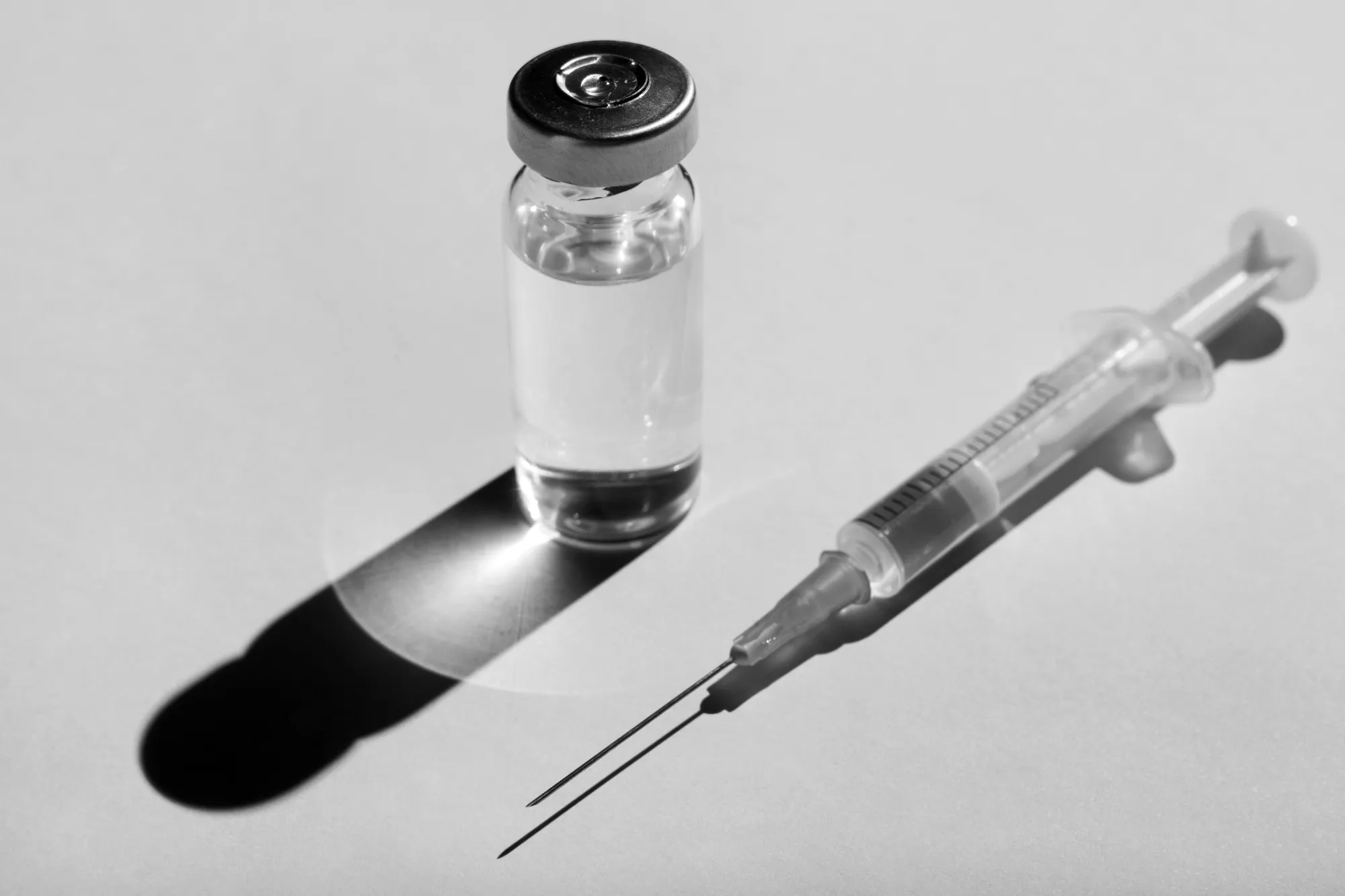 A close-up of a vial and syringe.