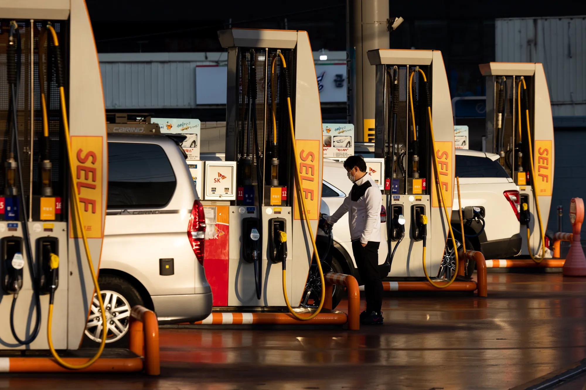 A driver refuels a vehicle at a SK Energy Co. gas station in Gimpo, South Korea.