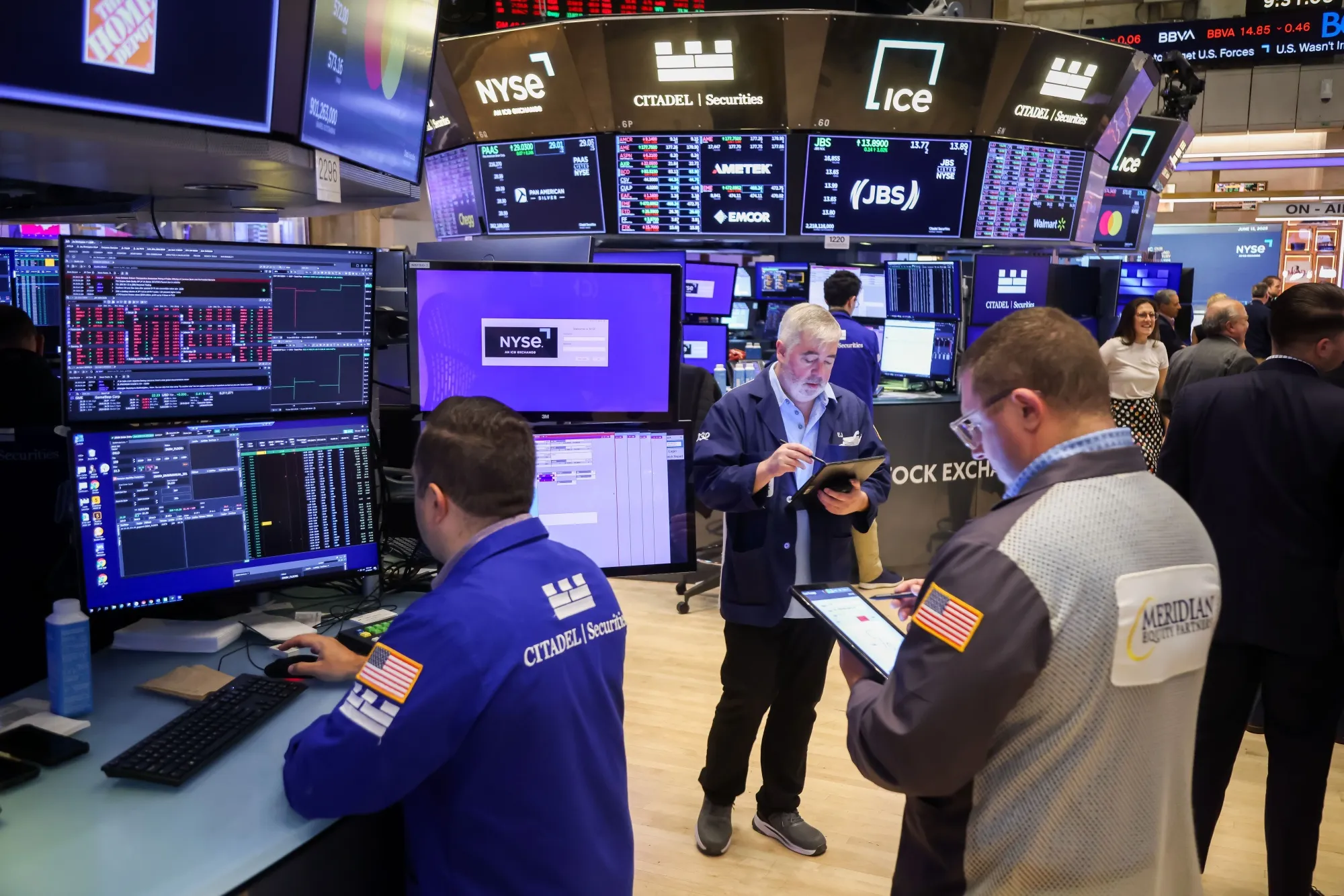 Traders work on the floor at the New York Stock Exchange.