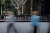 Pedestrians pass in front of the JPMorgan Chase & Co. headquarters building in New York, U.S., on Thursday, April 10, 2014.