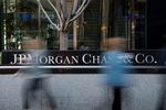 Pedestrians pass in front of the JPMorgan Chase & Co. headquarters building in New York, U.S., on Thursday, April 10, 2014.