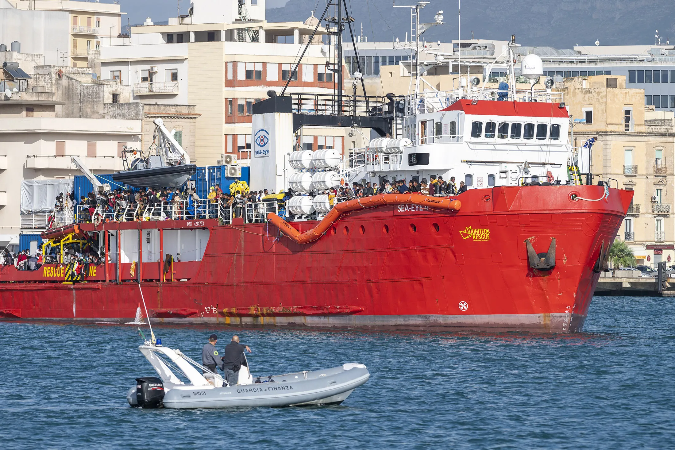 Migrants rescued in the Mediterranean sea arrive to disembark from the Sea-Eye 4 ship at the port of Trapani, Sicily, on Nov. 7.