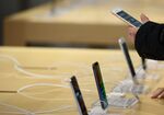 A customer looks at an Apple Inc. iPhone 8 at a SoftBank Group Corp. store in Tokyo, Japan.