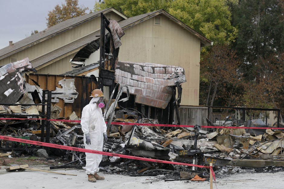 Workers remove debris at the site of a home destroyed by fire in the Coffey Park area of Santa Rosa on November 8, 2017.