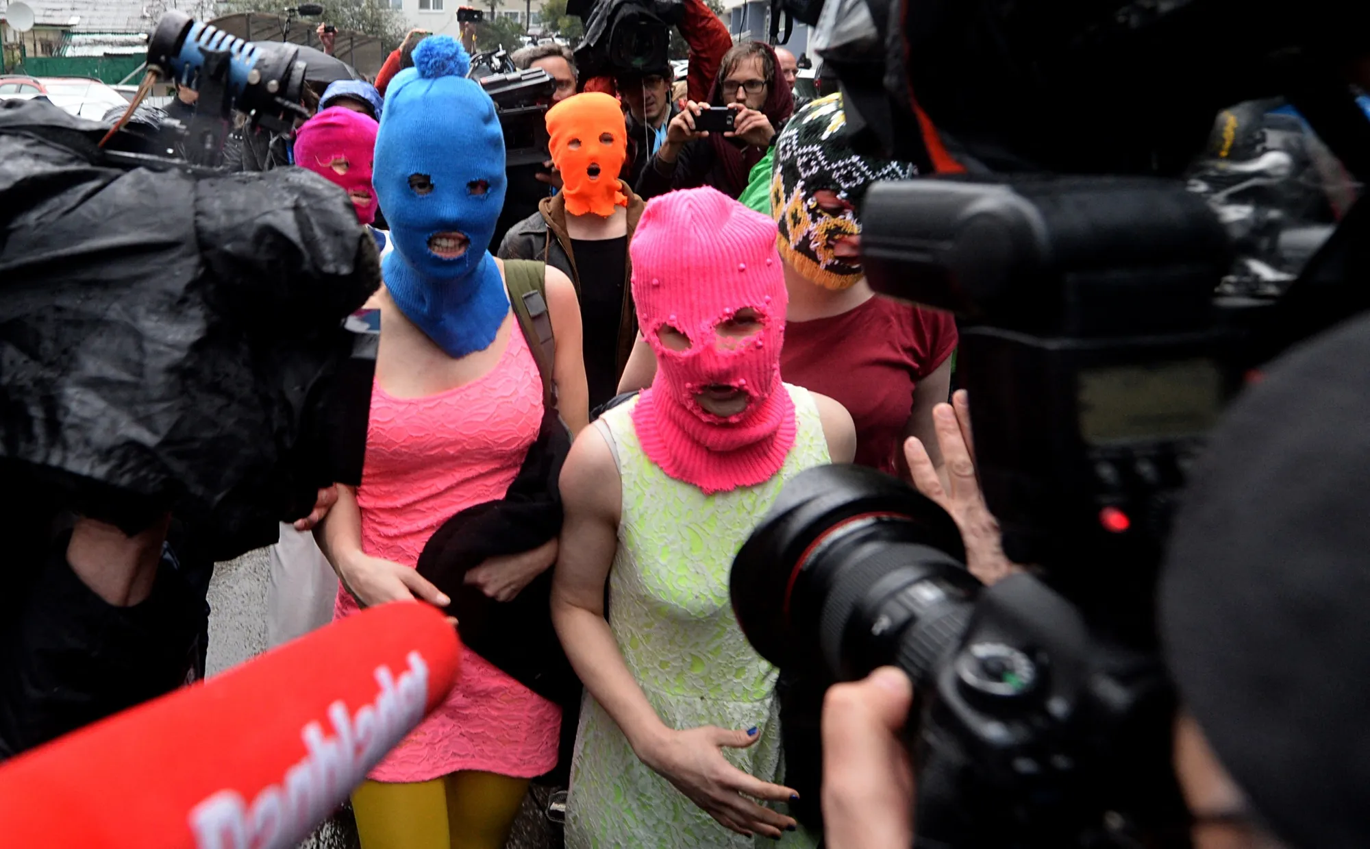 Members of Russian punk group Pussy Riot speak to journalists while leaving the police station of Adler, near Sochi, Russia in 2014.&nbsp;