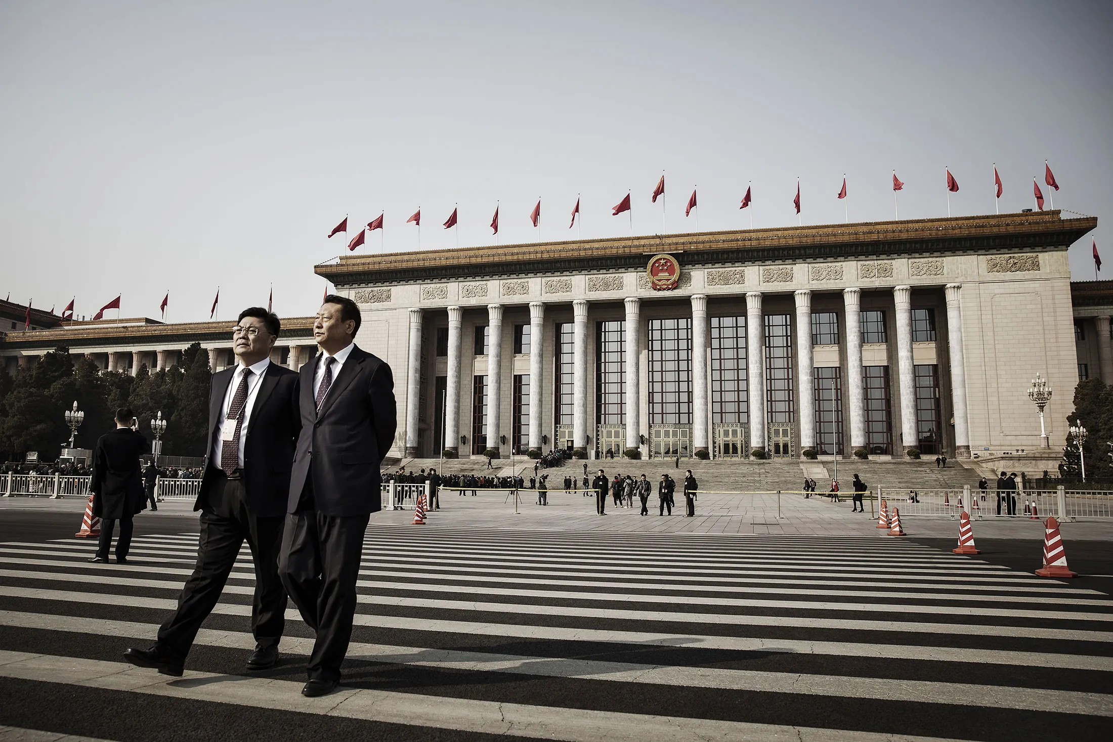 Delegates of the fifth session of the 12th Chinese People's Political Consultative Conference (CPPCC) cross a road in front of the Great Hall of the People in Beijing, China, on March 4.
