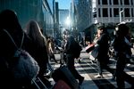 Pedestrians cross a street in Tokyo, Japan, on Monday, Dec. 15, 2025. Prime Minister Sanae Takaichi has promised various measures to tackle inflation in her upcoming economic package, which is expected to lessen the hit from price growth on households and businesses. Photographer: Ko Tsuchiya/Bloomberg