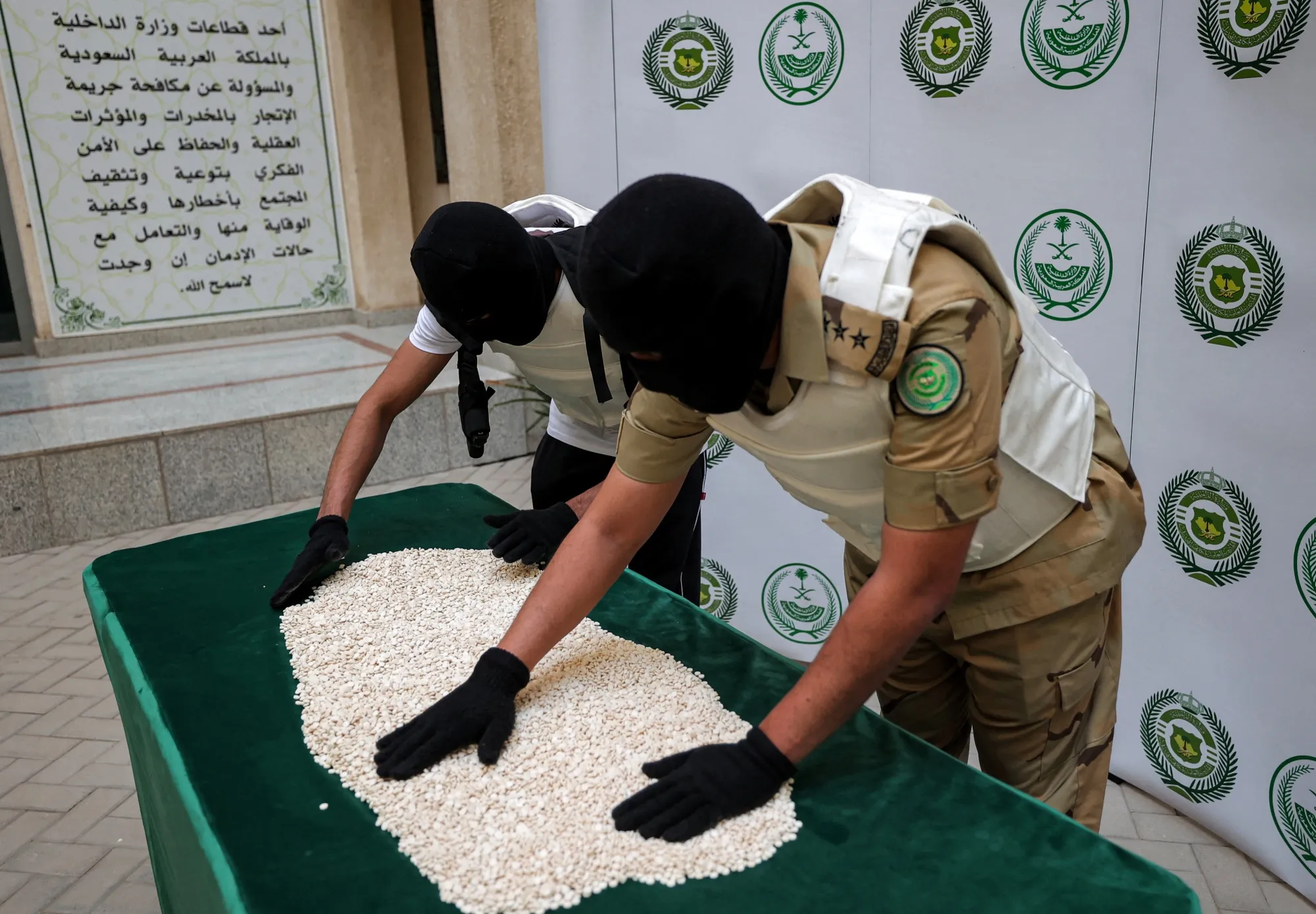 Officers of the Directorate of Narcotics Control sort through tablets of captagon seized during a special operation in Jeddah, in 2022.