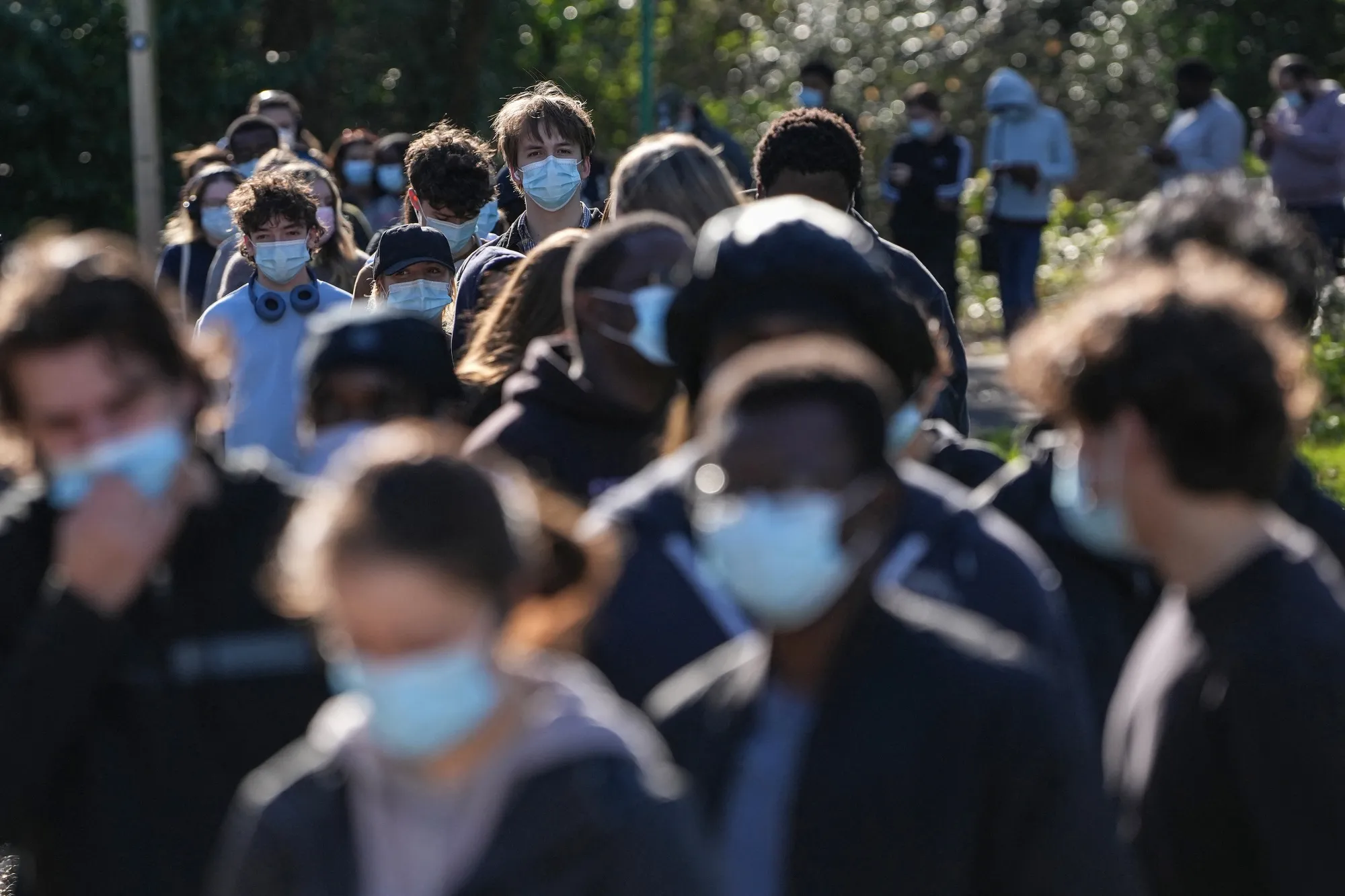 Students wearing face masks queue up to get vaccinated at the University of Kent in Canterbury, on March 18.