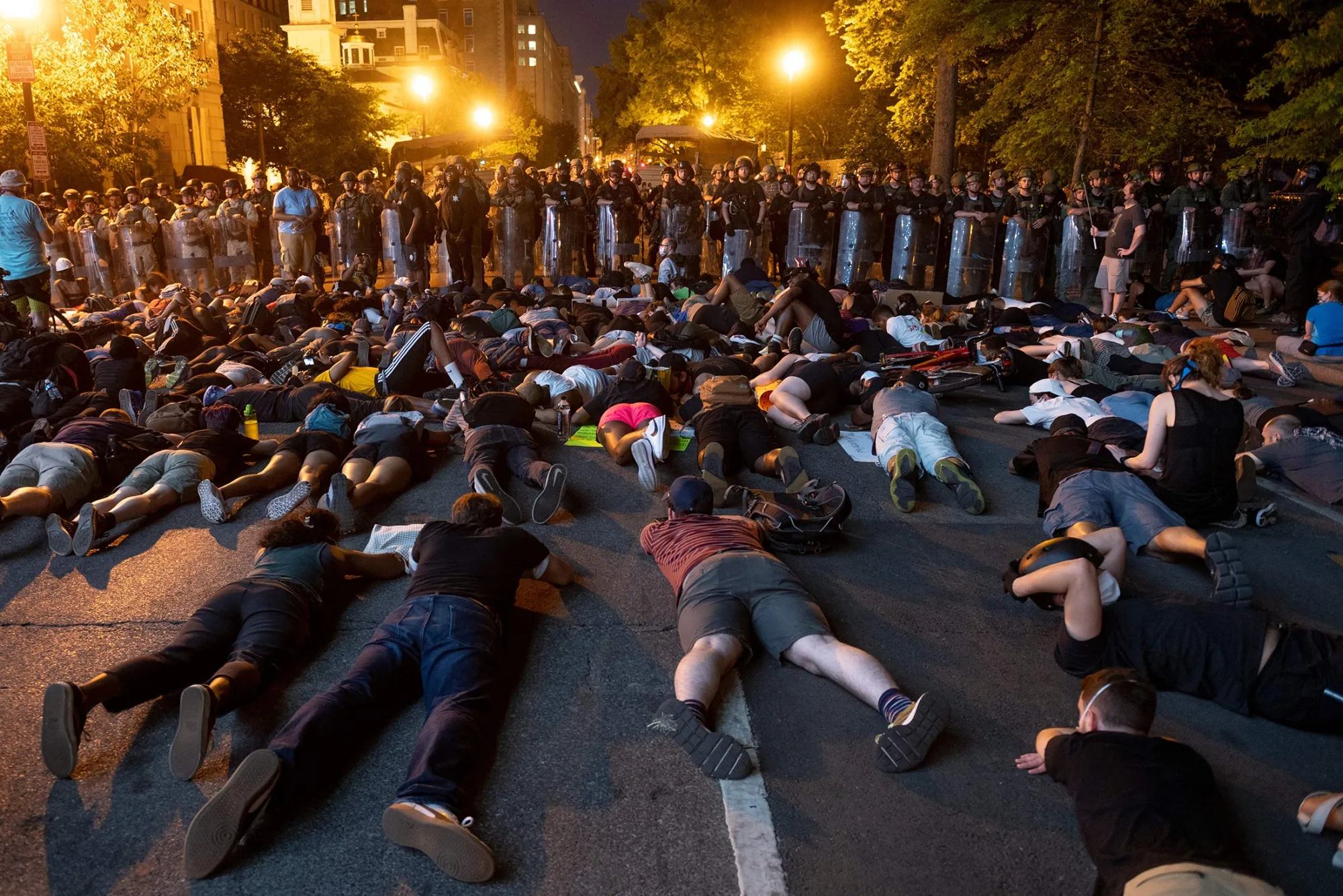 Demonstrators lay on the ground facing a police line in front of the White House during protests over the death of George Floyd.