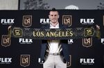 Gareth Bale poses for photos after being introduced as a new member of the Los Angeles FC MLS soccer club Monday, July 11, 2022, in Los Angeles. (AP Photo/Marcio Jose Sanchez)