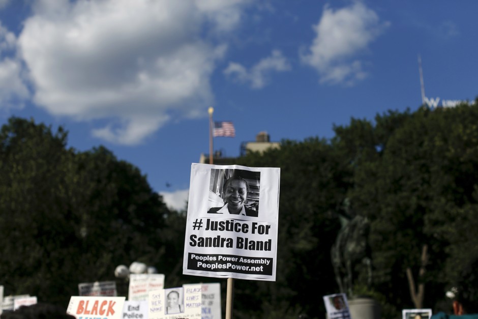 Demonstrators hold signs picturing Sandra Bland and Kindra Chapman, both of whom died in police custody, during a protest in New York.