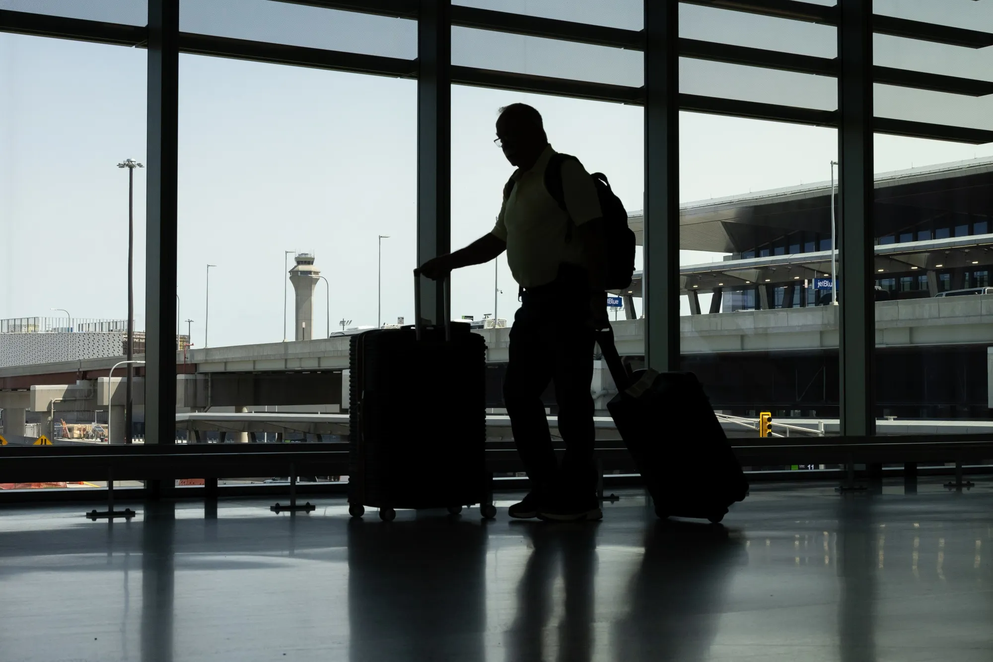 The FAA Air Traffic Control tower past a traveler at Newark Liberty International Airport&nbsp;in Newark, New Jersey.