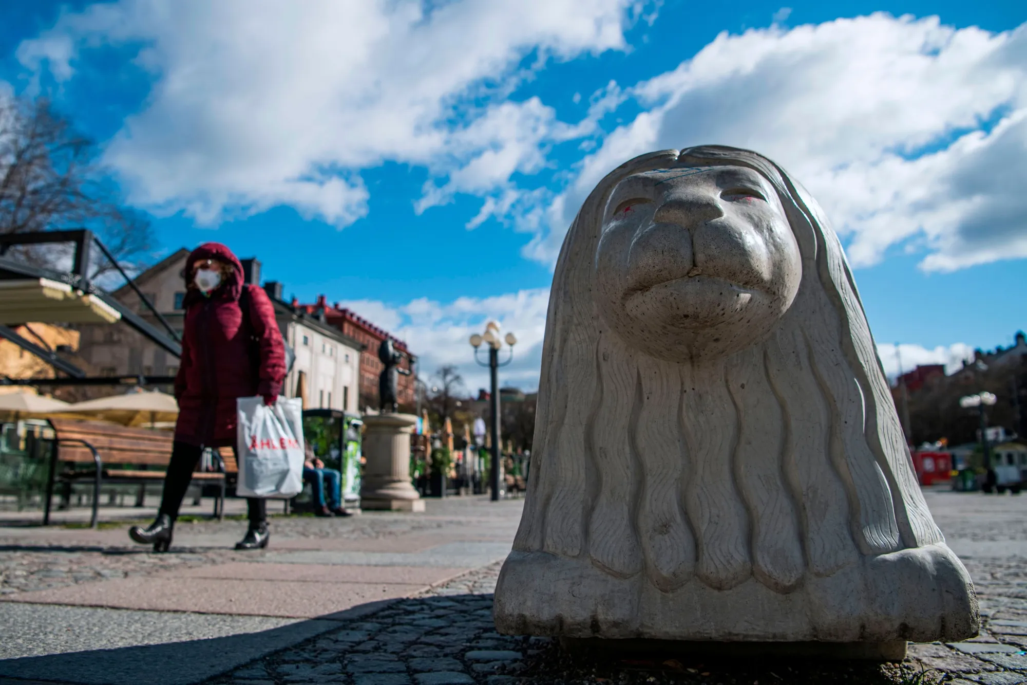 A pedestrian wears a face mask in Sodermalm district, Stockholm.
