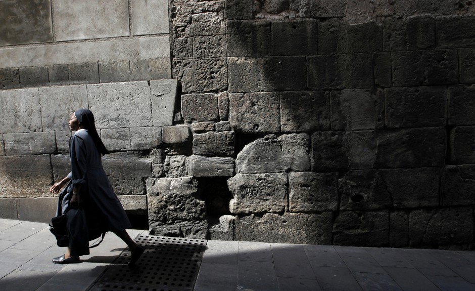 A nun walks through an alleyway in Barcelona's Ciutat Vella