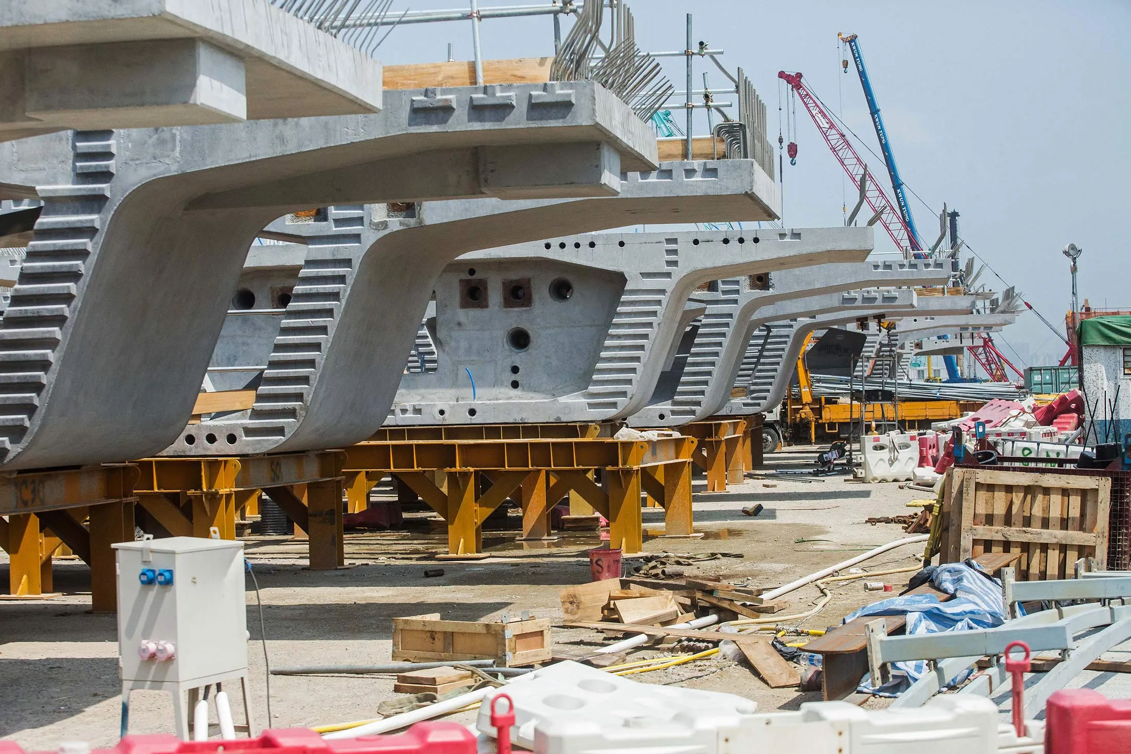 Concrete sections stand at the construction site of the Hong Kong-Zhuhai-Macau Bridge (HZMB) in Hong Kong, China, on Tuesday, March 28, 2017. Hong Kong’s next chief executive will inherit an economy vulnerable to China's growing pains on one side and volatile global capital flows on the other.
