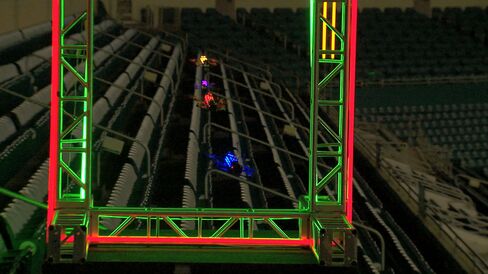 Drones whoosh through a checkpoint in Miami Dolphins stadium.
