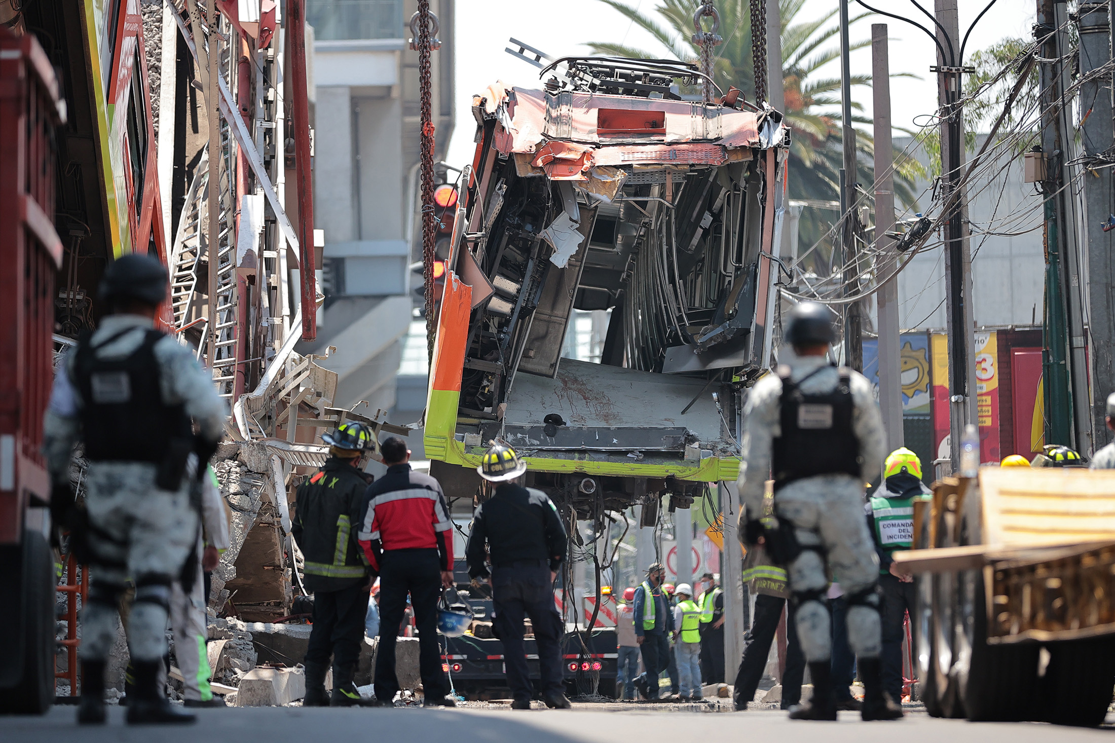 Emergency personel work to remove the debris of carriages in the area where a train overpass collapsed in Mexico City, on May 4.