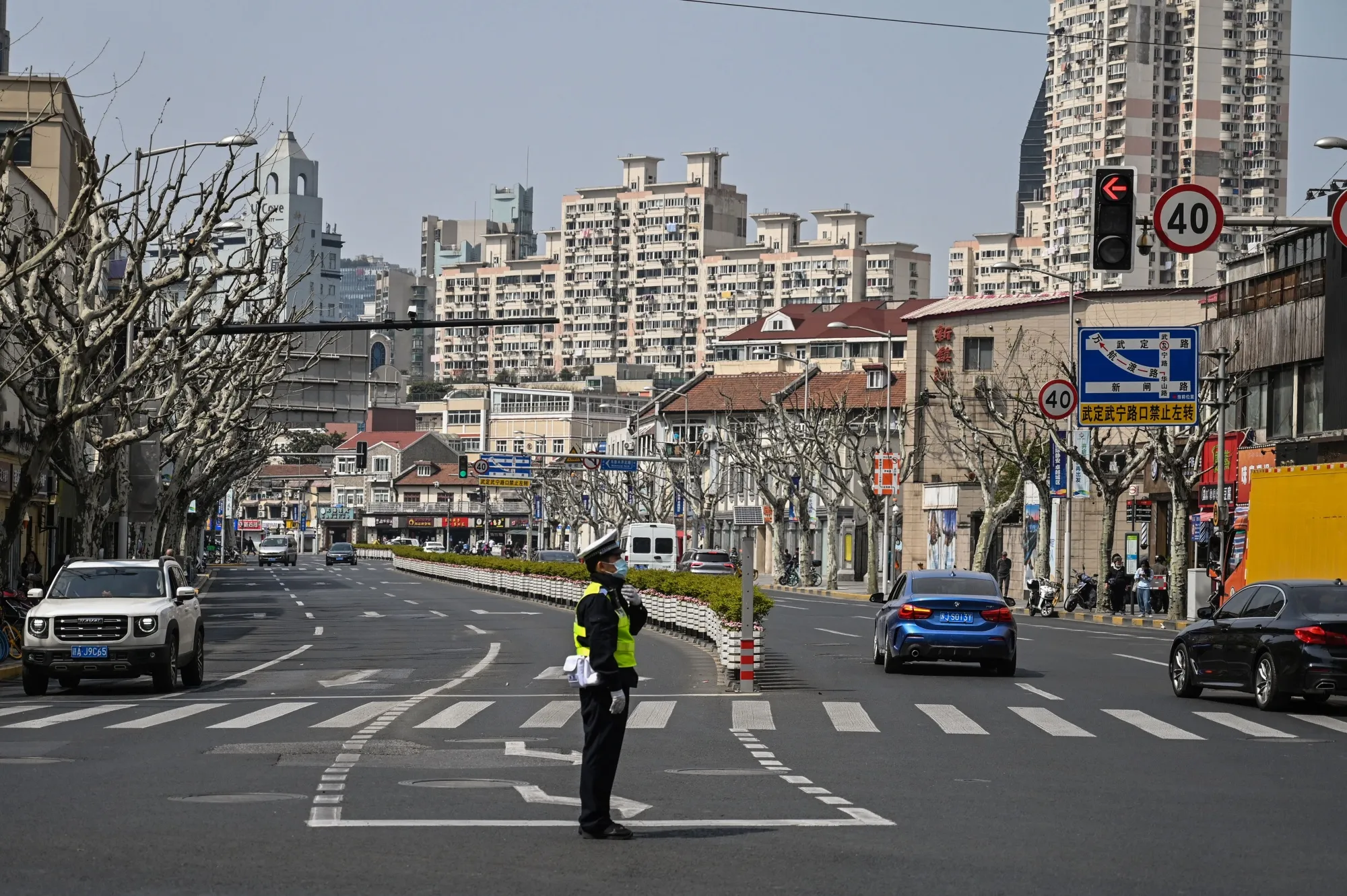 A policeman directs traffic on a street in Shanghai on March 16.