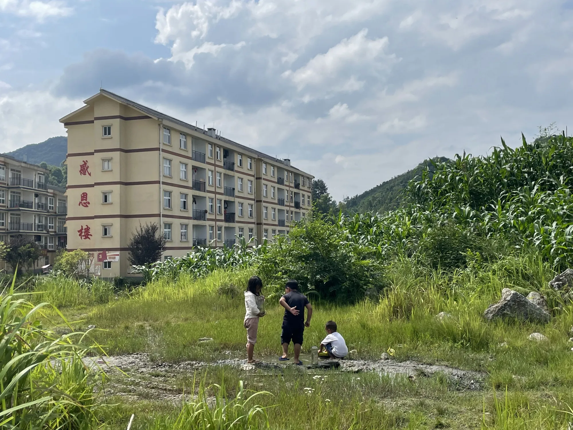 Children play near the Kangshun Relocation Compound in Guizhou province.