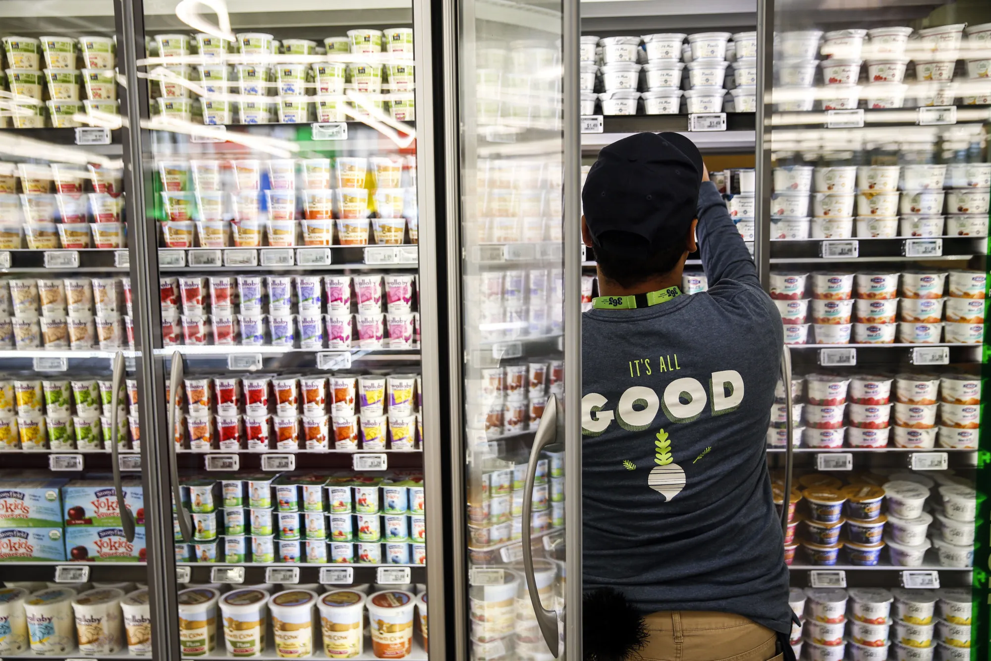 An employee stocks yogurt for sale on the opening day of the 365 by Whole Foods Market store in the Silver Lake neighborhood of Los Angeles, California, U.S., on Wednesday, May 25, 2016. Whole Foods Market Inc., plans to open 10 of the grocery stores in 2017 with a focus on everyday low prices and convenience.