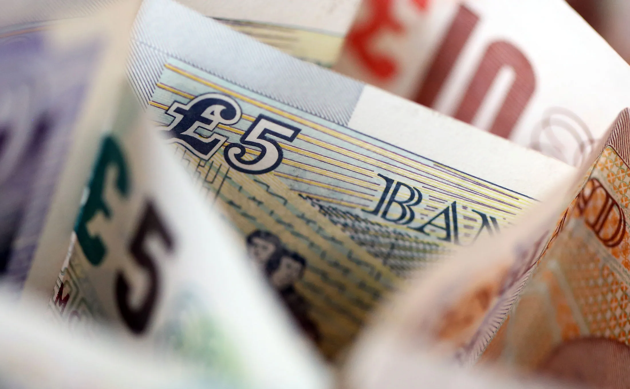 British five, 10 and 20 pound banknotes stand in this arranged photograph in London, U.K., on Tuesday, Feb. 9, 2016. The pound has been falling versus the dollar since the middle of 2015 and accelerated its slide this year, reaching an almost seven-year low of $1.4080 on Jan. 21.

