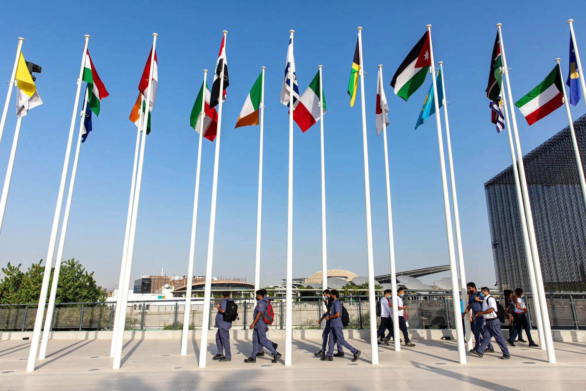 Workers at the entrance to the Expo 2020 exhibition site in Dubai.&nbsp;