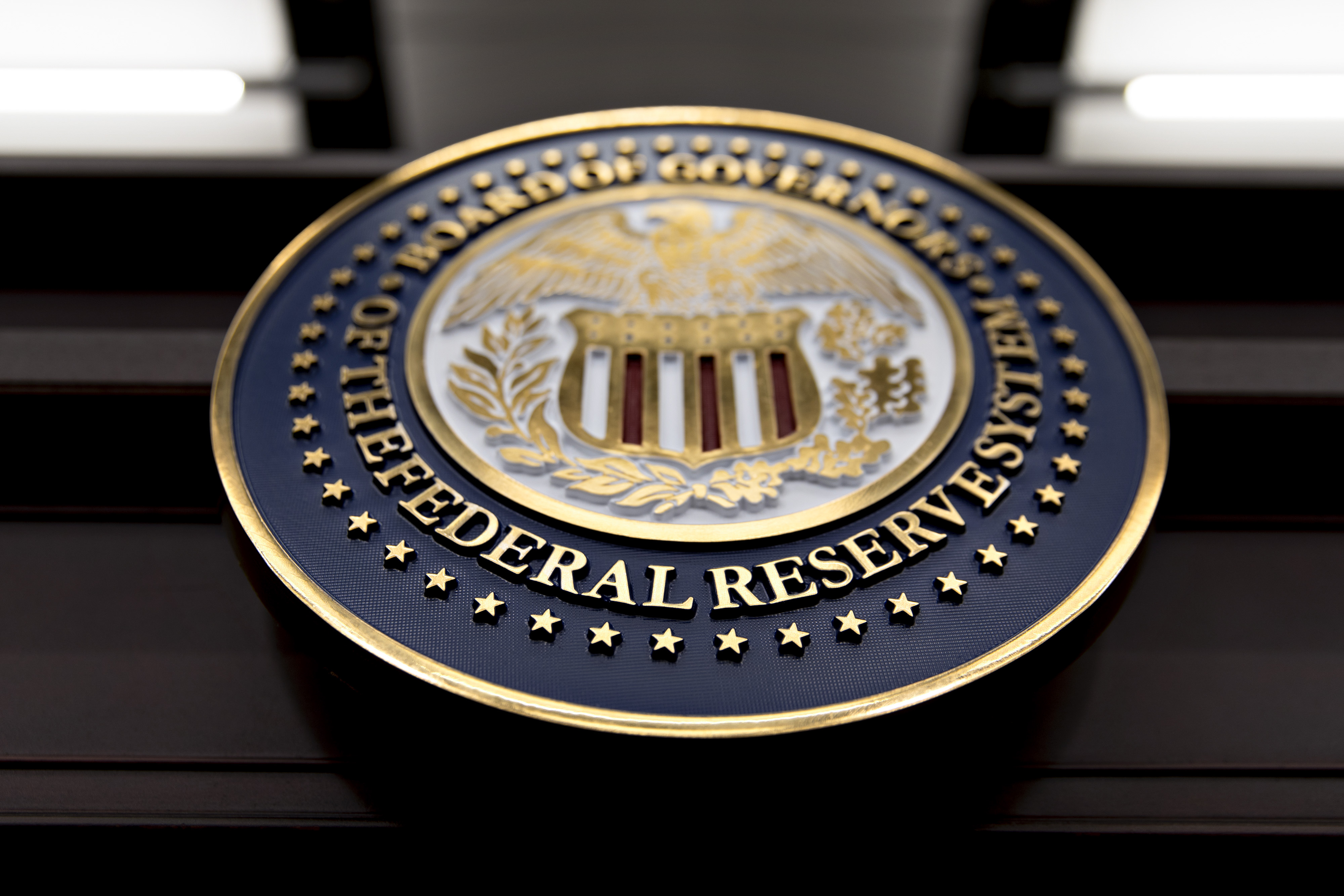 The seal of the Board of Governors of the Federal Reserve System hangs on a table before a news conference with Federal Reserve Chair Janet Yellen following a Federal Open Market Committee (FOMC) meeting in Washington, D.C., U.S., on Wednesday, Dec. 13, 2017. 