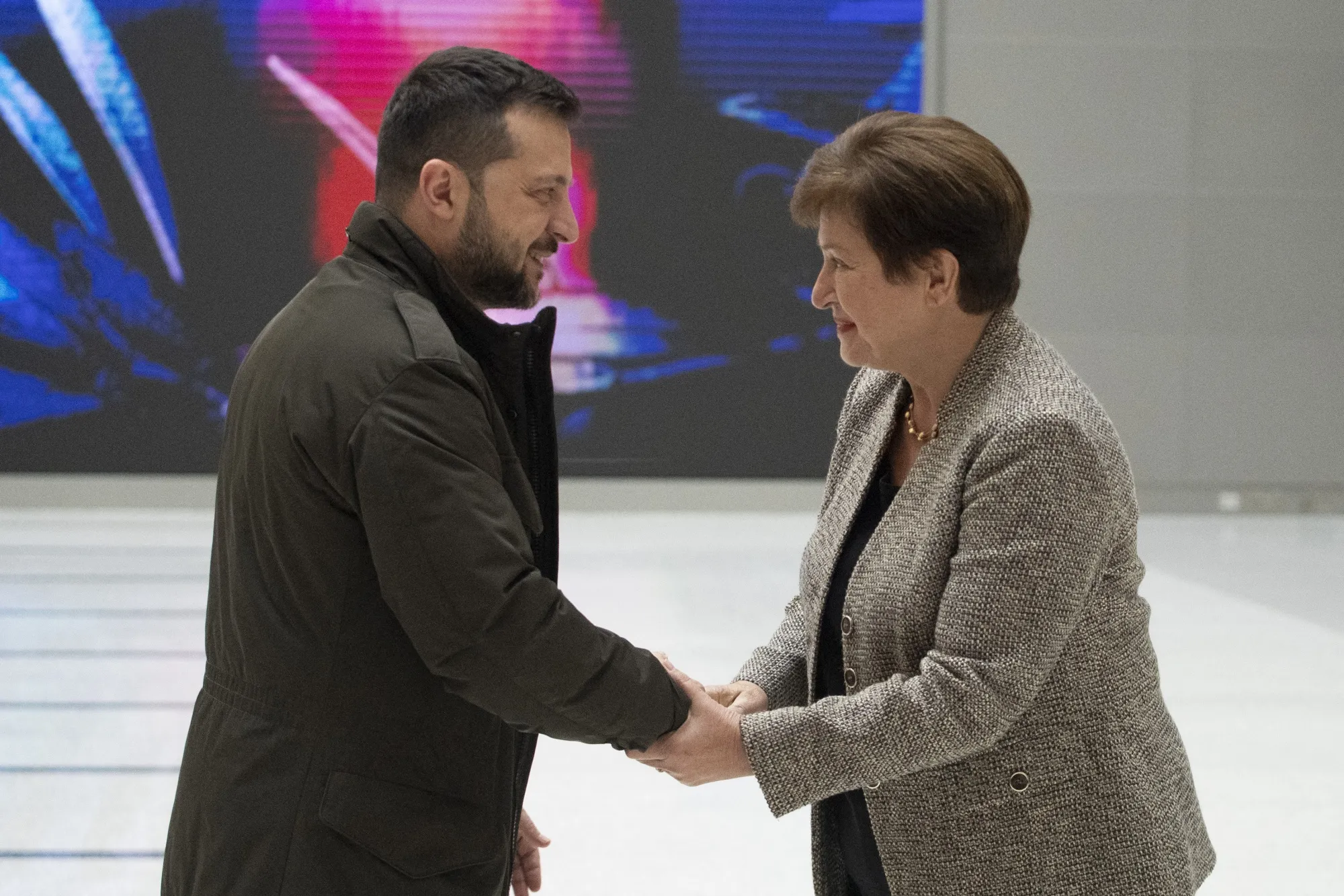 Volodymyr Zelenskiy and Kristalina Georgieva shake hands at the IMF in Washington, DC, on Dec. 11.