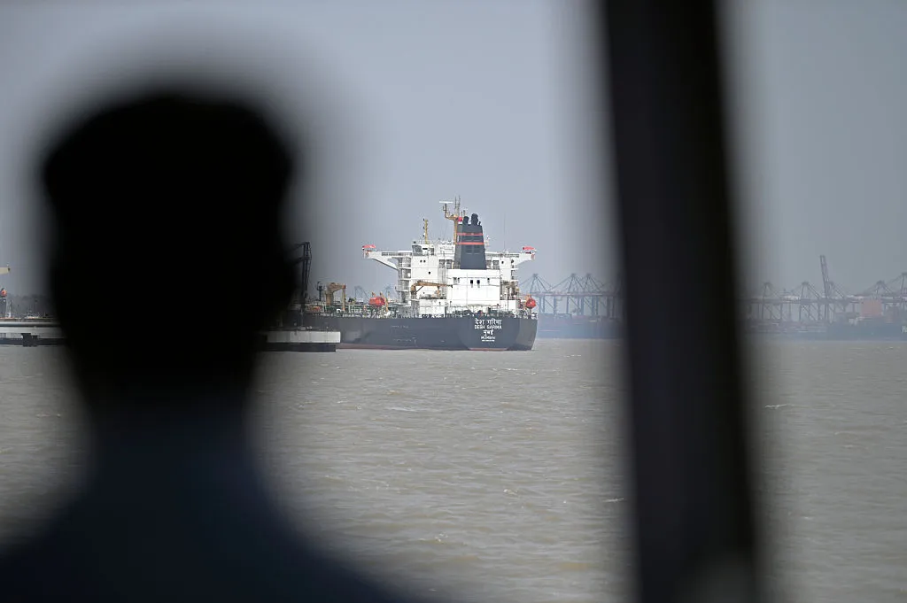 A tanker unloads crude oil at an offloading terminal after transiting the Strait of Hormuz on April 30.&nbsp;