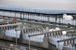 Bottles of Nestle Vera water move on the production line at a bottling plant in Castrocielo, Italy.