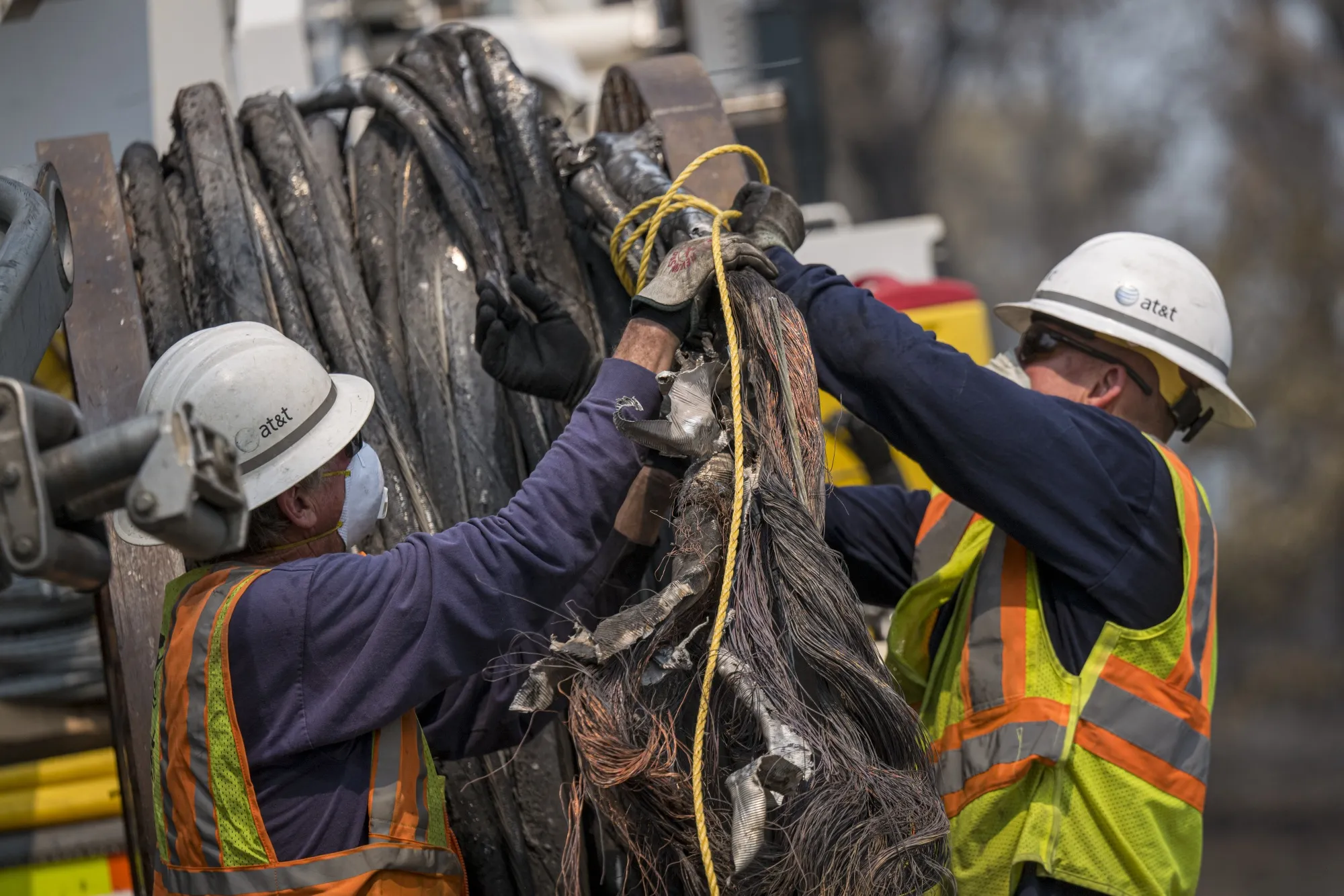AT&amp;T&nbsp;linemen repair telephone cables damaged by wildfire, in Napa County, California, on Aug. 25.