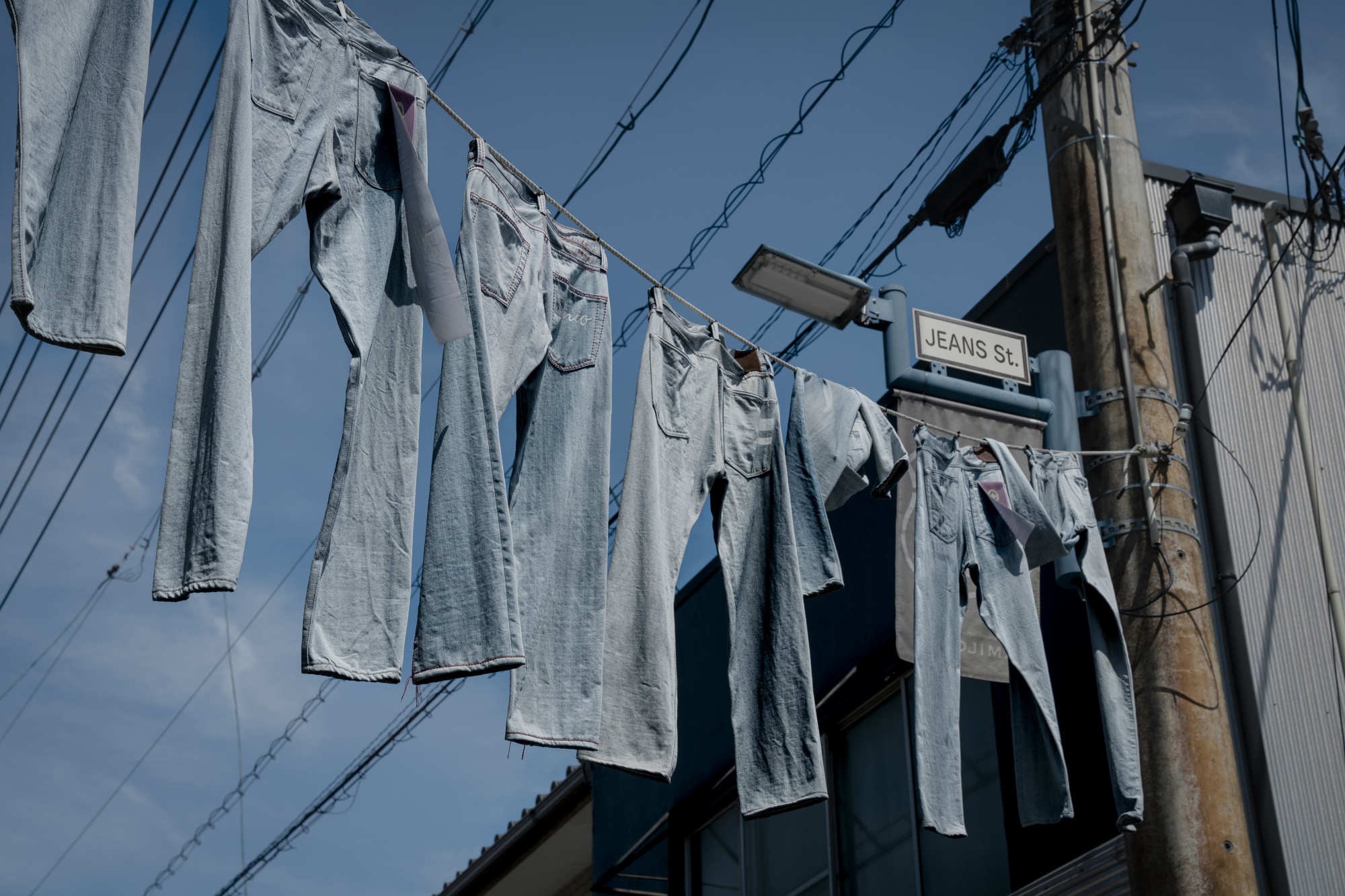 Denim hanging over Jeans Street in Okayama prefecture, home to Japan’s top denim manufacturers and stores.