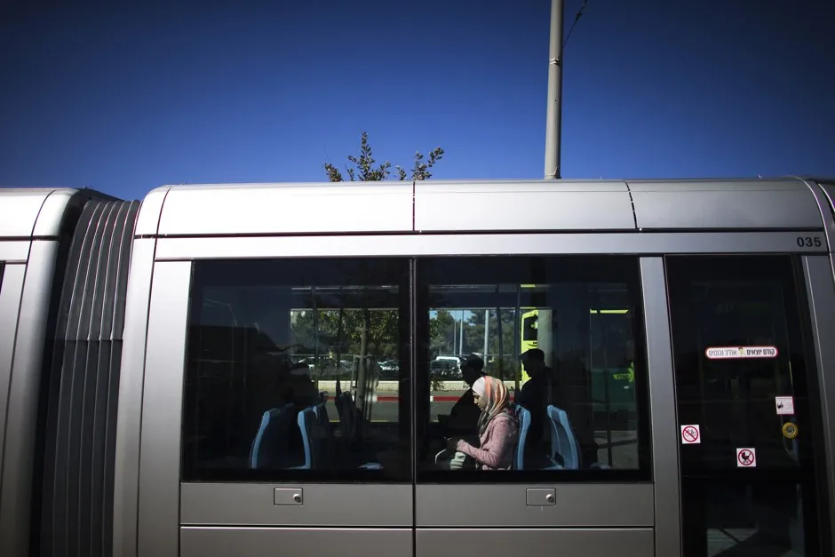A woman rides a light rail train in Jerusalem.